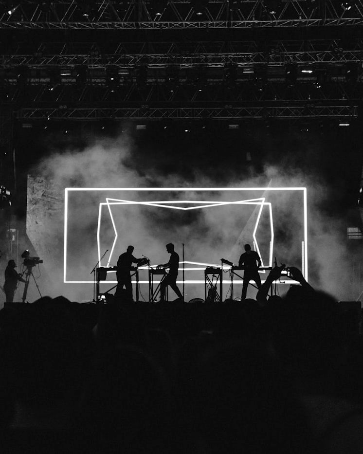 Black-and-white wide shot of a concert stage